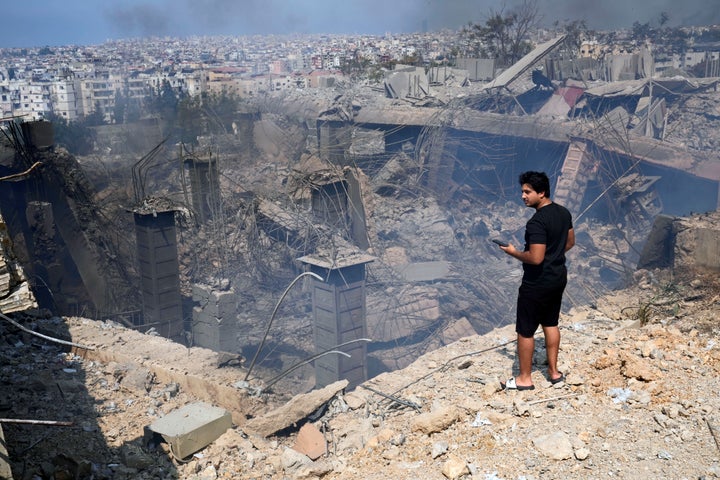 A man checks a damaged building at the site of an Israeli airstrike in Choueifat, south east of Beirut, Saturday, Sept. 28, 2024. (AP Photo/Hussein Malla)