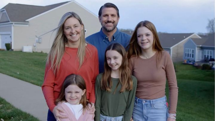 Republican Derrick Anderson, who is running for Virginia's seventh congressional district, poses in a photo with a family that is not his.