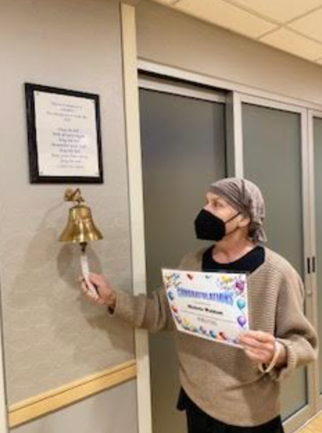 The author ringing the bell for her last day of radiation treatments in March 2024.