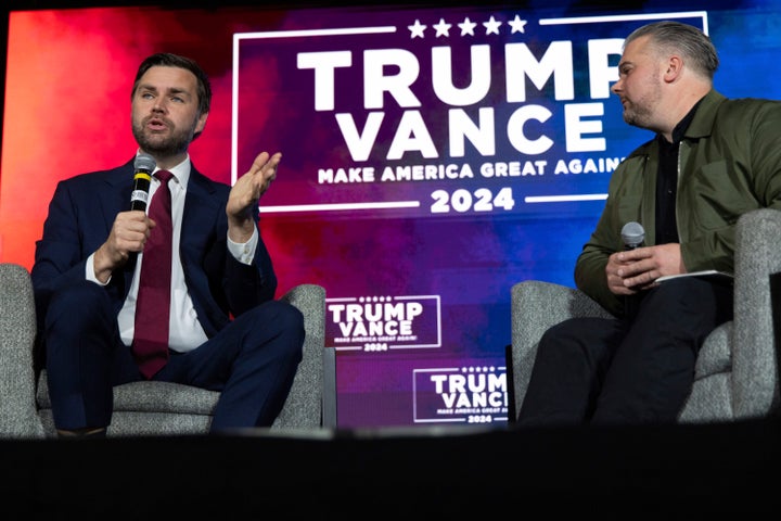 Republican vice presidential nominee Sen. JD Vance (R-Ohio), left, answers a question in a campaign town hall with Jason Howard, a pastor, at the Monroeville Convention Center in Monroeville, Pennsylvania, on Sept. 28, 2024.