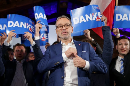Supporters hold "Thank You" banners behind Herbert Kickl, leader of the Freedom Party of Austria, in Vienna, Austria, Sunday, Sept. 29, 2024, after polls closed in the country's national election. (AP Photo/Heinz-Peter Bader)