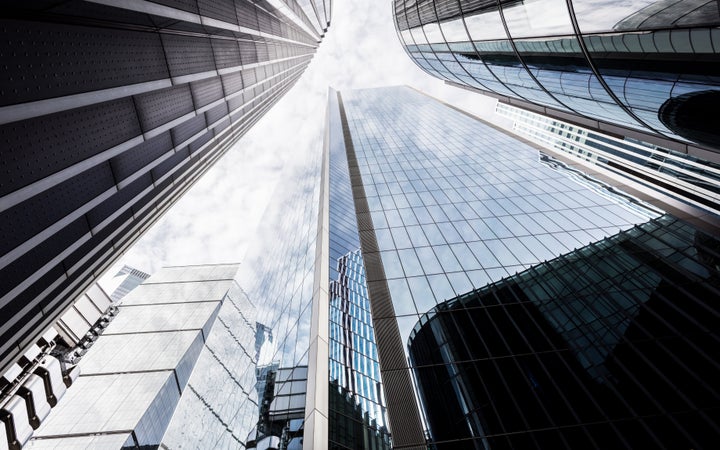 Low angle view of modern glass skyscrapers, City of London, UK