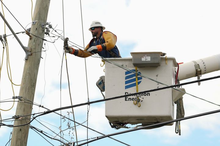 A Dominion Energy lineman works on a power line in the aftermath of Hurricane Helene Sunday, Sept. 29, 2024, in North Augusta, S.C. (AP Photo/Artie Walker Jr.)