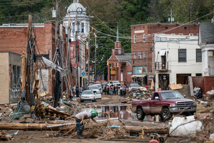 Workers, community members, and business owners clean up debris in the aftermath of Hurricane Helene in Marshall, North Carolina on Monday, Sept. 30, 2024. (Photo by Jabin Botsford/The Washington Post via Getty Images)