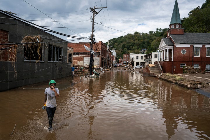 Workers, community members, and business owners clean up debris in the aftermath of Hurricane Helene in Marshall, North Carolina on Monday, Sept. 30, 2024. (Photo by Jabin Botsford/The Washington Post via Getty Images)