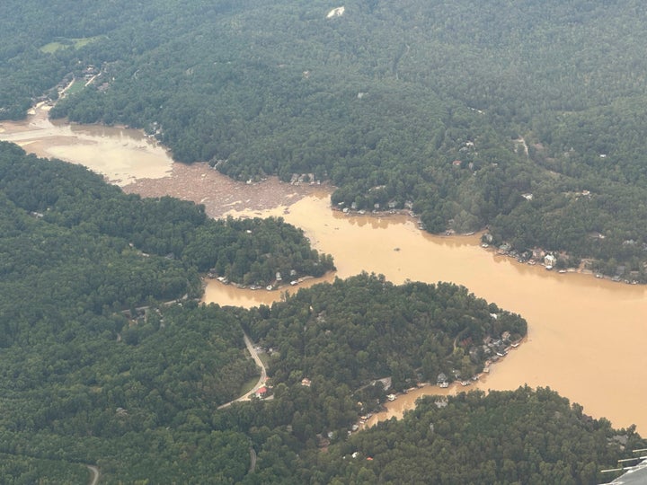 Storm debris in the waters of Lake Lure in Rutherford County, N.C., near the village of Chimney Rock, as seen from overhead from a North Carolina National Guard plane on Monday, Sept. 30, 2024. (AP Photo/Gary D. Robertson)