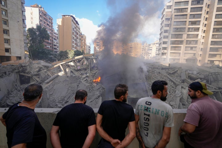 People check the site of an Israeli airstrike in Dahiyeh, Beirut, Lebanon, Wednesday, Oct. 2, 2024.