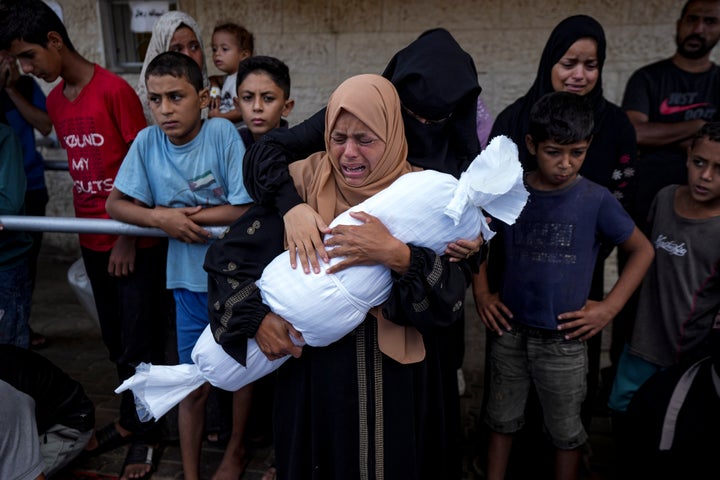 Palestinians mourn relatives killed in the Israeli bombardment of the Gaza Strip, at a hospital in Deir al-Balah, on Oct. 1, 2024.