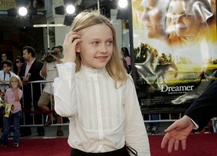 Dakota Fanning, seen here being ushered down the red carpet at the "Dreamer" premiere in 2005.