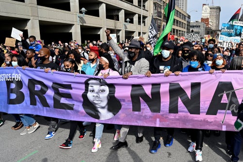 Tamika Palmer, center, the mother of Breonna Taylor, leads a march through the streets of downtown Louisville on March 13, 2021, a year after Taylor's death.