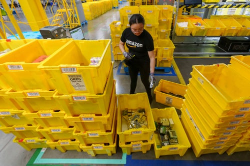 An employee scans incoming items at a receiving station at the Amazon OXR1 fulfillment center in Oxnard, Calif., on Aug. 21, 2024. (AP Photo/Damian Dovarganes, File)