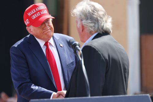 Former President Donald Trump shakes hands with Franklin Graham, president of the charity Samaritan's Purse, on Sept. 30 in Valdosta, Georgia.