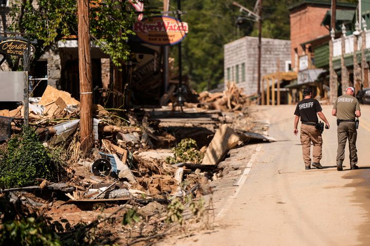 Two Sheriff deputies walk on the main street in the aftermath of Hurricane Helene, Wednesday, Oct. 2, 2024, in Chimney Rock Village, N.C. 