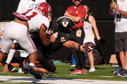 Vanderbilt quarterback Diego Pavia (2) dives for extra yards past Alabama linebacker Jihaad Campbell (11) during the first half of an NCAA college football game Saturday, Oct. 5, 2024, in Nashville, Tenn. (AP Photo/George Walker IV)