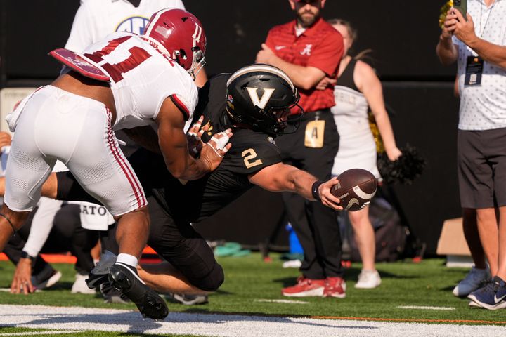 Vanderbilt quarterback Diego Pavia (2) dives for extra yards past Alabama linebacker Jihaad Campbell (11) during the first half of an NCAA college football game Saturday, Oct. 5, 2024, in Nashville, Tenn. (AP Photo/George Walker IV)