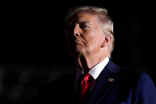 Donald Trump listens to opera singer Christopher Macchio, who performed in remembrance of the man killed at his rally in July.