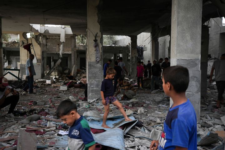 Palestinians examine a destroyed mosque following an Israeli airstrike in Deir al-Balah, Sunday, Oct. 6, 2024. (AP Photo/Abdel Kareem Hana)