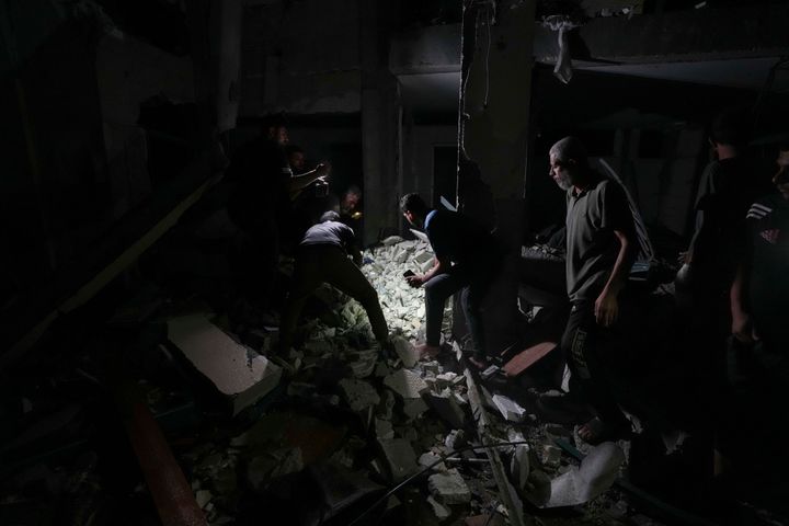 Palestinians search for survivors and bodies in the rubble of a mosque destroyed in an Israeli airstrike in Deir al-Balah, Sunday, Oct. 6, 2024. (AP Photo/Abdel Kareem Hana)