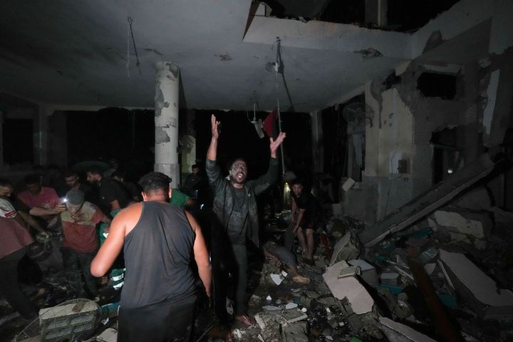 Palestinians search for survivors and bodies in the rubble of a mosque destroyed in an Israeli airstrike in Deir al-Balah, Sunday, Oct. 6, 2024. (AP Photo/Abdel Kareem Hana)