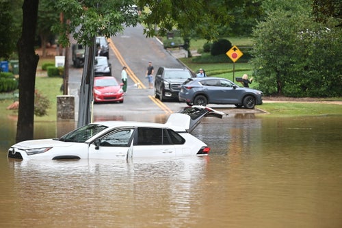 A car in a flooded street is seen after Hurricane Helene made landfall in Atlanta on Sept. 27, 2024.