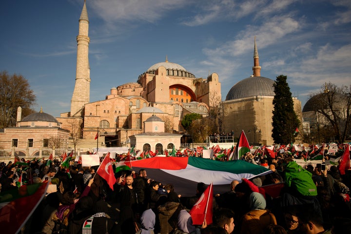 People hold a Palestinian flag during a pro Palestinians protest marking the World Human Rights Day outside Hagia Sophia mosque, in Istanbul, Turkey, Sunday, Dec. 10, 2023. (AP Photo/Emrah Gurel)