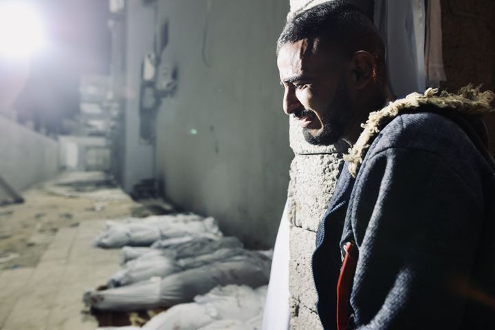 JIBALIYA, GAZA - OCTOBER 06: A man mourns near bodies of Palestinians at Kamal Adwan Hospital after dozens were killed in an Israeli attack on Jibaliya camp, northern Gaza on October 06, 2024.