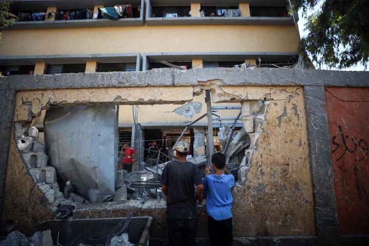 Palestinians inspect a school Thursday that the Israeli army attacked in Deir al-Balah, Gaza.