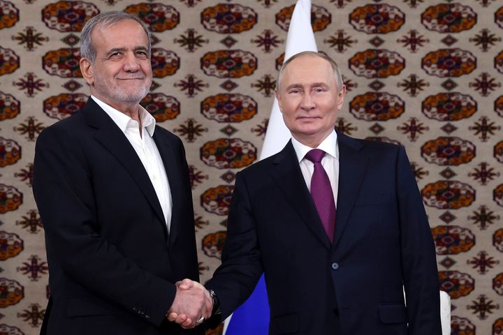 Russian President Vladimir Putin, right, and Iranian President Masoud Pezeshkian pose for a photo in Ashgabat, Turkmenistan, Friday, Oct. 11, 2024.