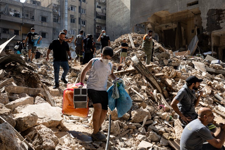 Items are recovered from the rubble of the bombed building, Israeli forces bombed the Ras al-Nabaa district on October 11, 2024 in Beirut, Lebanon. (Photo by Ugur Yildirim/ dia images via Getty Images)