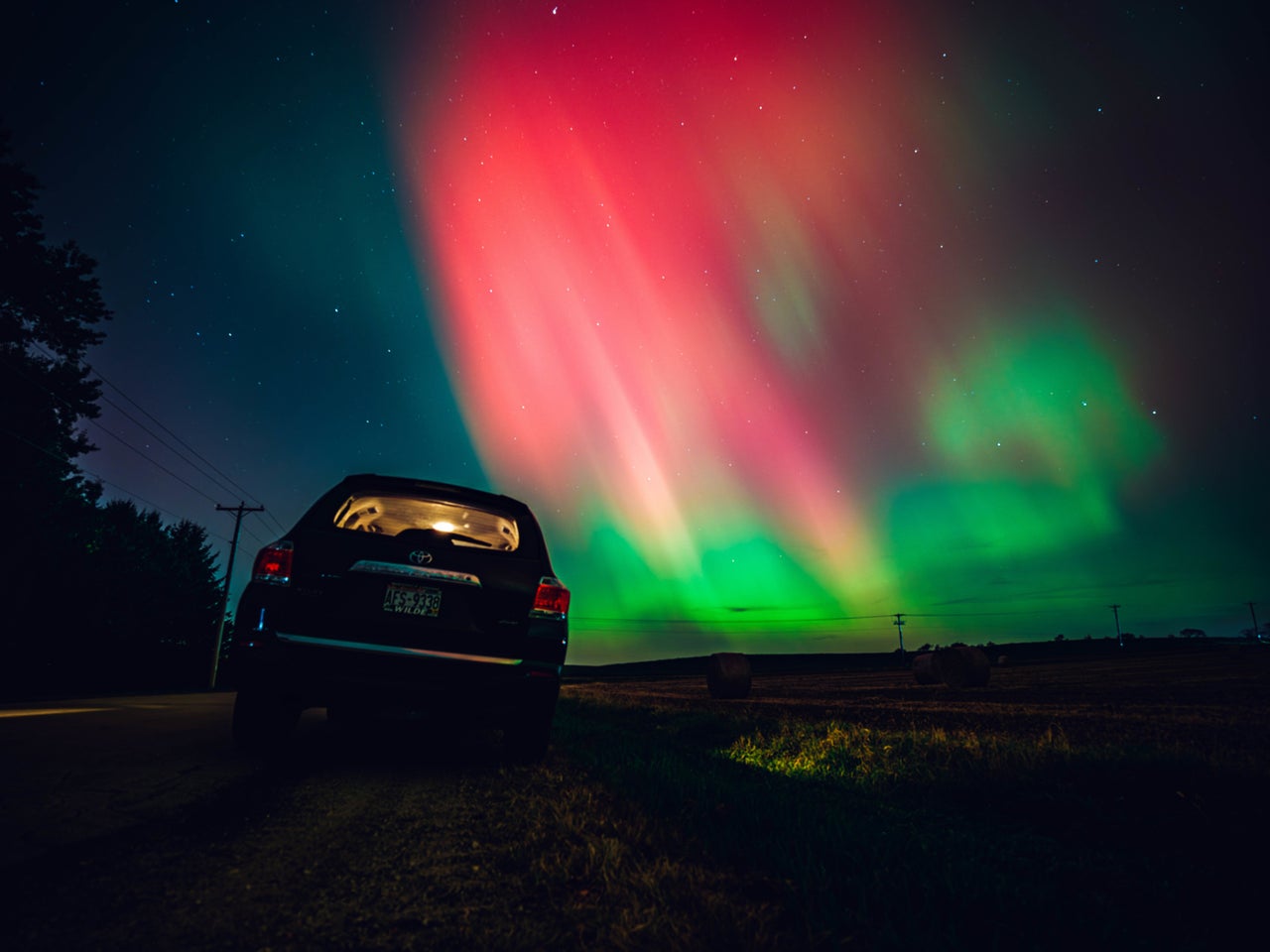 The night sky in Wisconsin glows with the northern lights as a geomagnetic storm brings vibrant pink and green colors to a majority of the northern U.S. on Thursday.