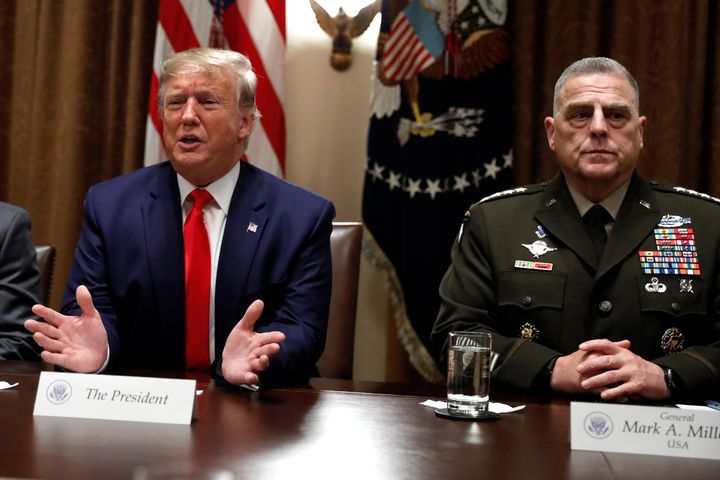 Former President Donald Trump speaks as Mark Milley, right, listens during a briefing with senior military leaders at the White House in Washington, Oct. 2019. (AP Photo/Carolyn Kaster)