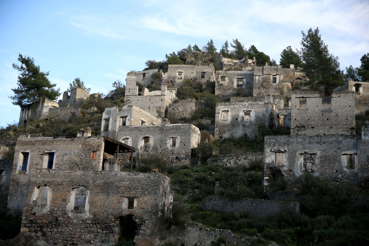 MUGLA, ΤΟΥΡΚΙΑ - 6 ΙΑΝΟΥΑΡΙΟΥ: Άποψη από το Kayakoy, γνωστό ως "χωριό-φάντασμα" στη Μούγλα της Τουρκίας στις 6 Ιανουαρίου 2024. Τα μουσεία και οι αρχαιολογικοί χώροι της πόλης, ένα από τα σημαντικότερα τουριστικά κέντρα της Τουρκίας, φιλοξένησαν πέρυσι 1 εκατομμύριο 164 χιλιάδες 151 επισκέπτες. Υποδεχόμενη εκατομμύρια τουρίστες, η Μούγλα ξεχωρίζει επίσης με τον ιστορικό της πλούτο. Το Μουσείο Υποβρύχιας Αρχαιολογίας του Μπόντρουμ, που βρίσκεται στο Κάστρο του Μπόντρουμ, ήταν το μουσείο με τις περισσότερες επισκέψεις, ενώ οι βραχώδεις τάφοι Amintas του Φετιγιέ και το Kayakoy ήταν οι αρχαιολογικοί χώροι με τις περισσότερες επισκέψεις. (Φωτογραφία: Ali Riza Akkir/Anadolu via Getty Images)