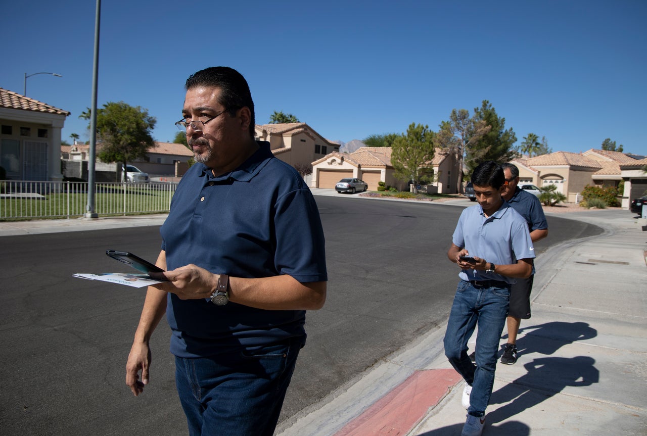 From left: Jesus Marquez, son Jesus Jr. and fellow churchgoer Efren Gonzalez canvass for Republican candidates on Sept. 28 in Las Vegas.