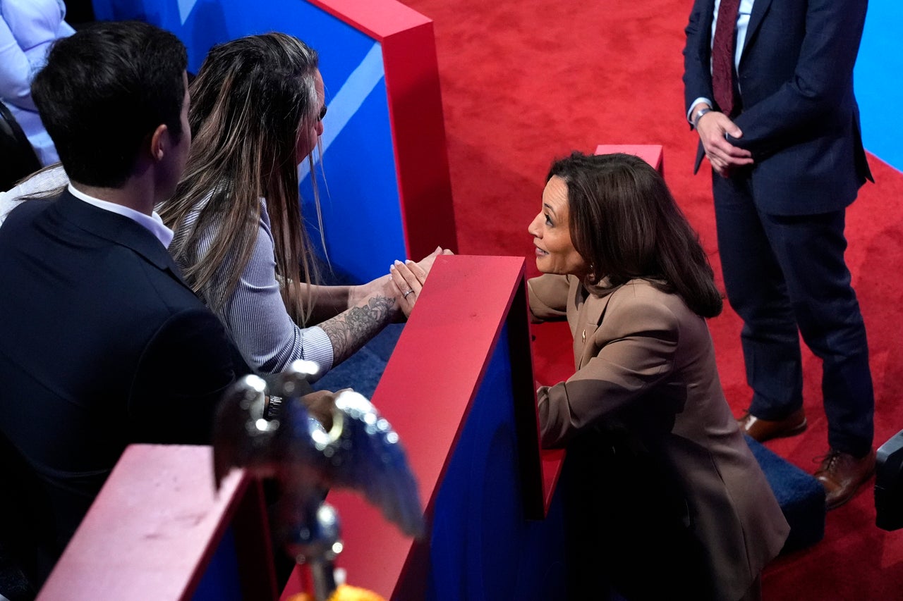 Kamala Harris (right) holds the hand of Ivett Castillo, of Las Vegas, at the conclusion of the Oct. 10 Univision town hall. She emphasized border security in her remarks on immigration.