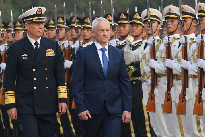 In this photo released by Russian Defence Ministry press service on Monday, Oct. 14, 2024, Chinese Defence Minister Dong Jun, left, and Russian Defence Minister Andrei Belousov walk during welcoming ceremony in Beijing, China.