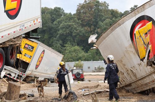 Members of a Federal Emergency Management Agency task force search a flood-damaged area in Asheville, North Carolina, on Oct. 4.