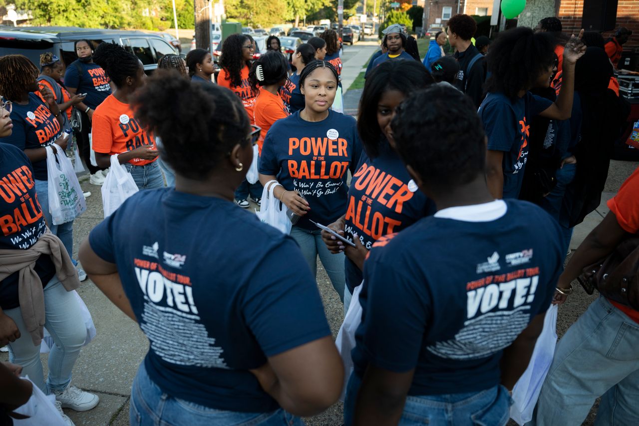 Power of the Ballot volunteers gather for a get-out-the-vote event on Saturday, Oct. 12, at Sharp Skills barber shop in Philadelphia.