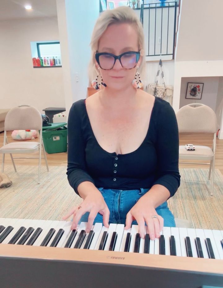 The author plays an electric piano that her husband bought for her one Christmas.