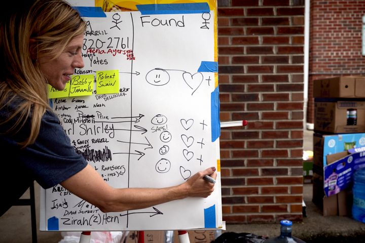 A woman makes a note of people who were considered missing but are now safe, at a church in Swannanoa, North Carolina.