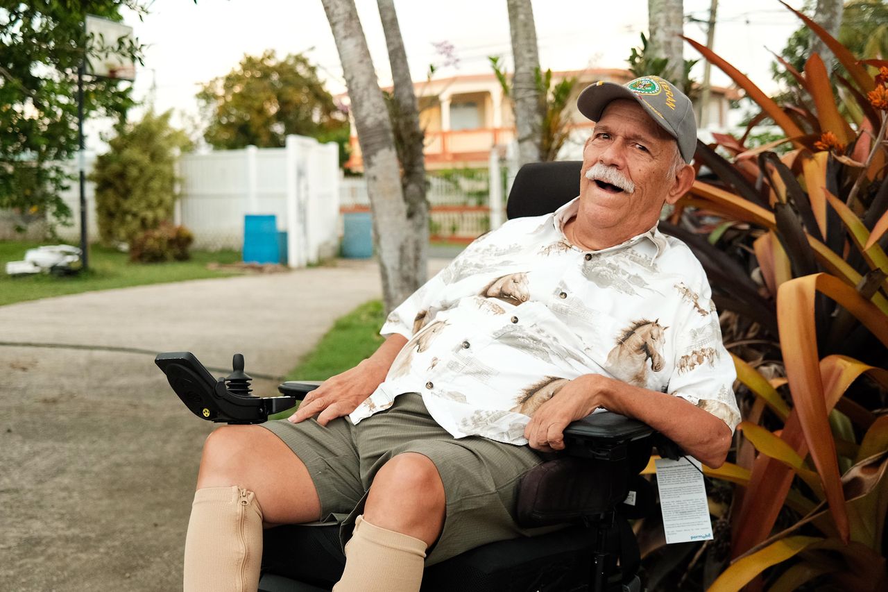 Angel Manuel Ciordia, 75, sits outside his home in Vega Baja, Puerto Rico, about 45 minutes west of San Juan. Dependent on an electric wheelchair, bed and breathing machine to survive his degenerative muscular disease, Ciordia is distressed by the problems with Puerto Rico's grid and believes nuclear energy would help.