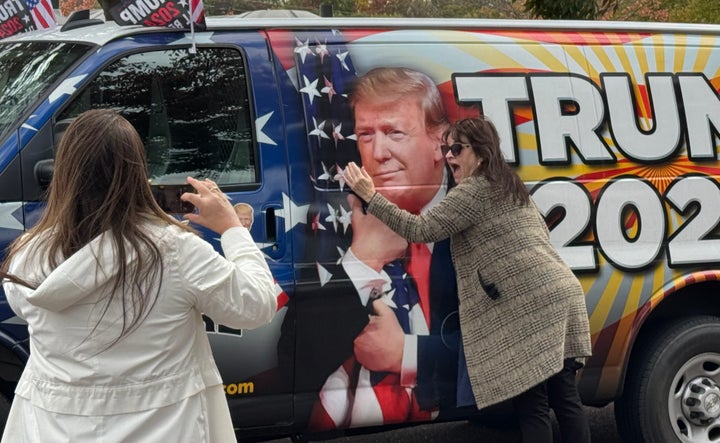 A Donald Trump supporter poses for a photo with his likeness in Oaks, Pennsylvania. According to a recent poll, 43% of female registered voters support Trump.