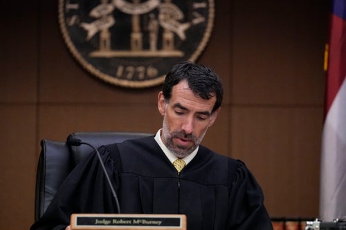 FILE - Fulton County Superior Court Judge Robert McBurney looks through paperwork, Monday, Aug. 14, 2023, in Atlanta. A judge on Friday, Sept. 8, is expected to release the full report compiled by a special grand jury that helped an investigation by the Georgia prosecutor who ultimately indicted former President Donald Trump and 18 others. (AP Photo/Brynn Anderson, File)
