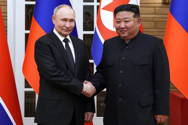 Russian President Vladimir Putin, left, and North Korea's leader Kim Jong Un shake hands while posing for a photo prior to their talks in Pyongyang, North Korea, Wednesday, June 19, 2024. 