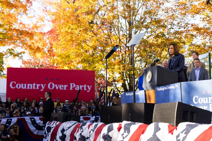 A banner reading "Country Over Party" is seen as US Vice President and Democratic presidential candidate Kamala Harris speaks at a campaign event at Washington Crossing.