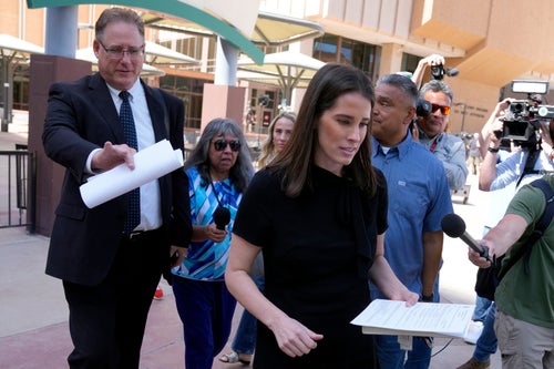 Christina Bobb, right, leaves Maricopa County Superior Court after her arraignment with attorney Thomas Jacobs, left, as she joined at least 11 other people who were also arraigned on several charges in their role in an effort to overturn Donald Trump's 2020 election loss in Arizona to Joe Biden Tuesday, May 21, 2024, in Phoenix. 