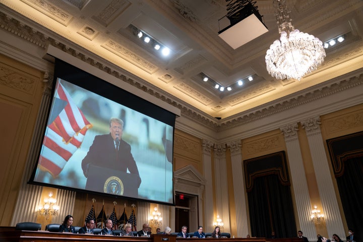 An image of President Donald Trump is displayed on a screen as the House Jan. 6 committee conducts its final hearing in December 2022. On Wednesday, Trump referred to the violent insurrection as "a day of love."