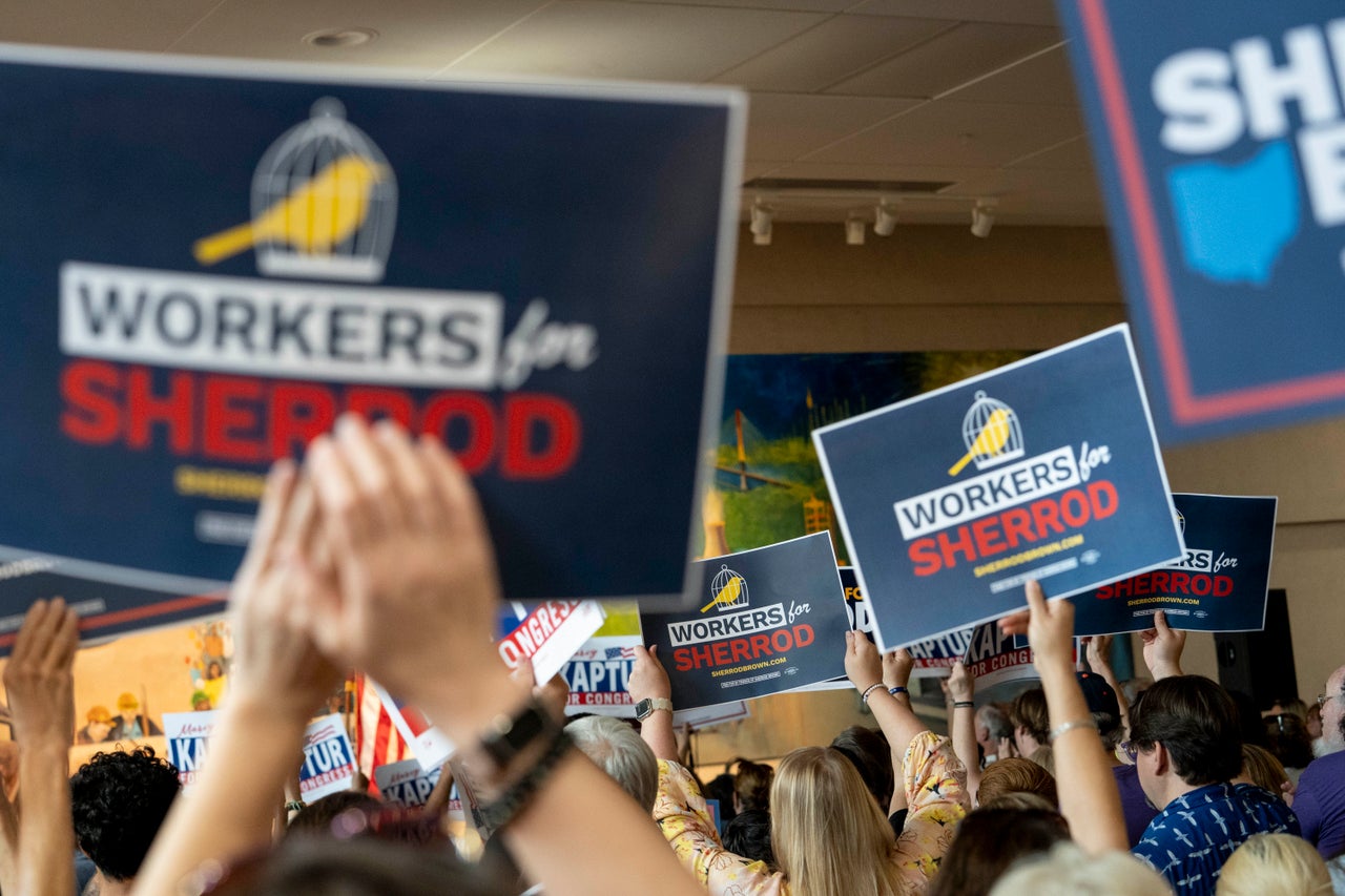 Attendees hold signs for Sen. Sherrod Brown at a rally at the UA Local 50 in Northwood, Ohio, on Sept. 14.