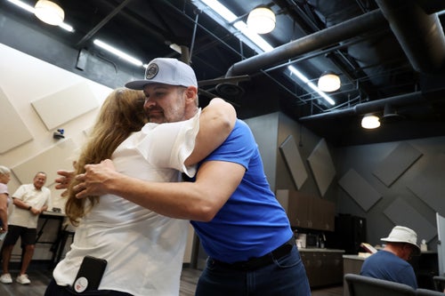 Jesse Law, chair of the Clark County Republican Party, embraces Krissian Marquez at Fervent Calvary Chapel Church on Saturday, Sept. 28, in Las Vegas.