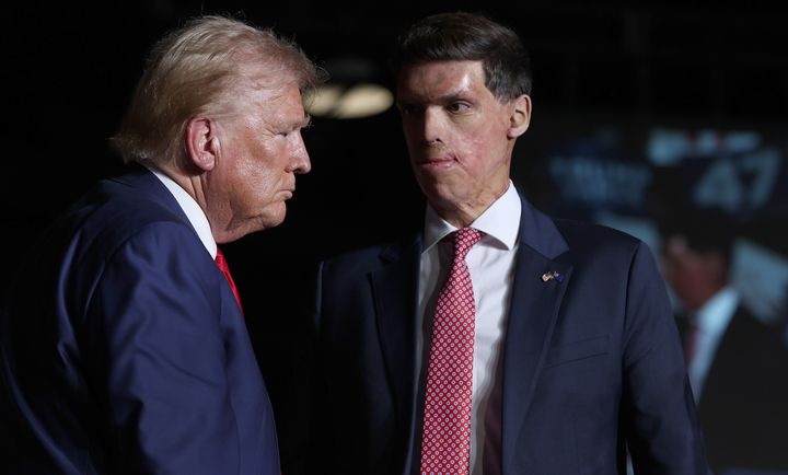 Former President Donald Trump stands with Sam Brown, a Republican candidate for Senate in Nevada, during a Sept. 13 campaign rally in Las Vegas. Brown ignored questions about Trump's mass deportation proposal at a campaign debate last month.