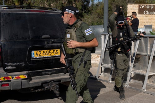 Israeli security forces secure a road near where Israel's government says a drone launched toward Israeli Prime Minister Benjamin Netanyahu's house in Caesarea, Israel Saturday, Oct. 19, 2024. (AP Photo/Ariel Schalit)